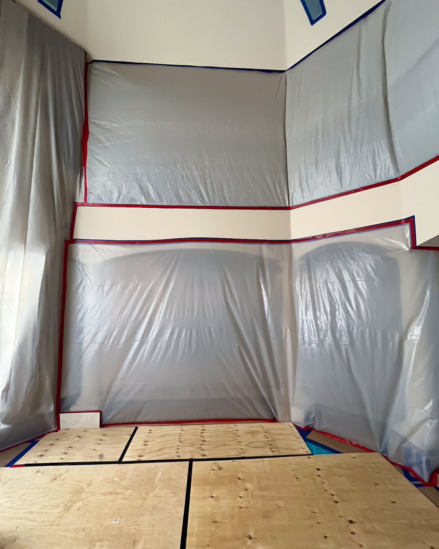 Plastic sheeting containment walls in room