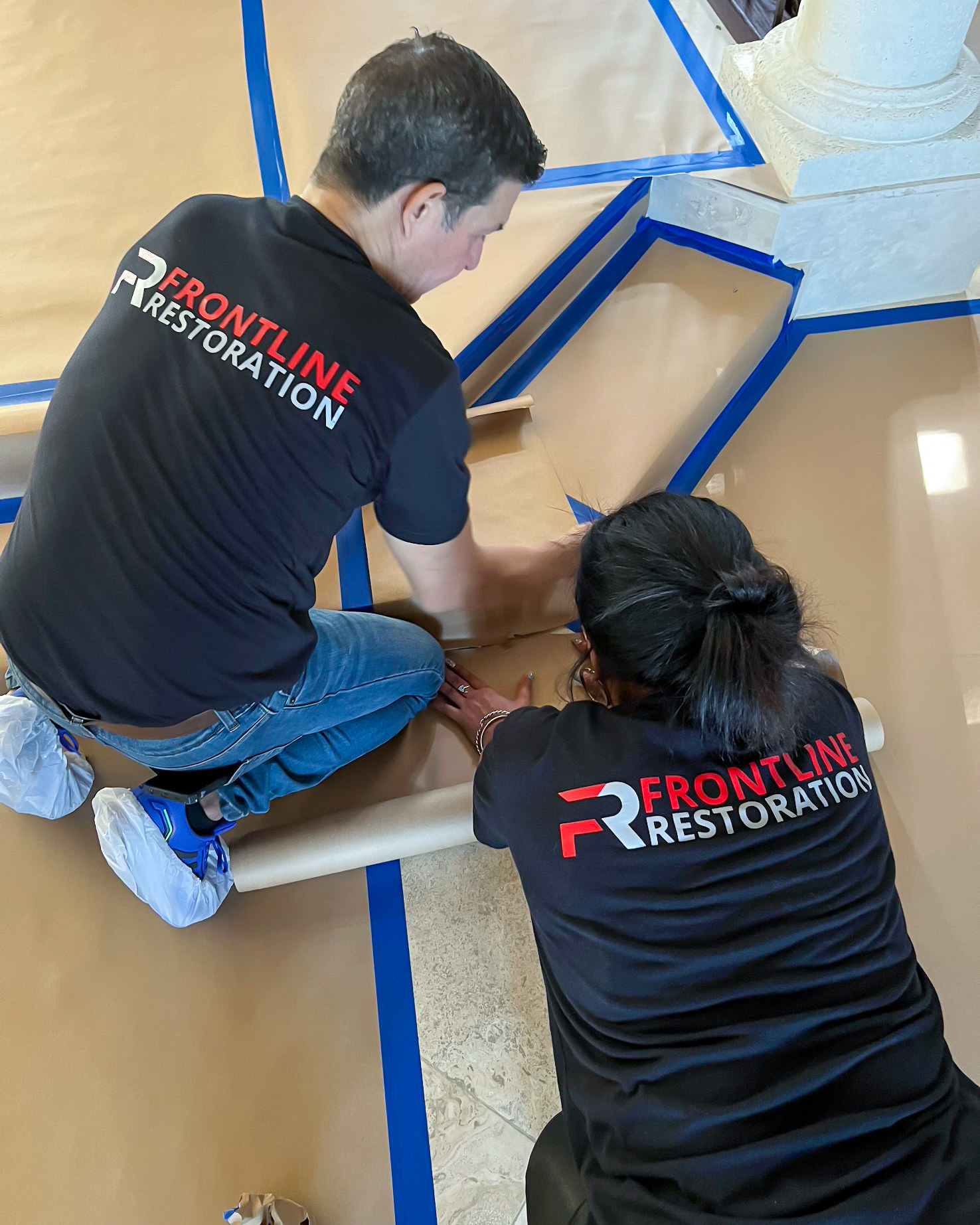 Frontline Restoration technicians at work in branded uniforms