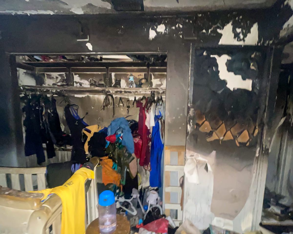 Fire-damaged closet with burned and charred clothing