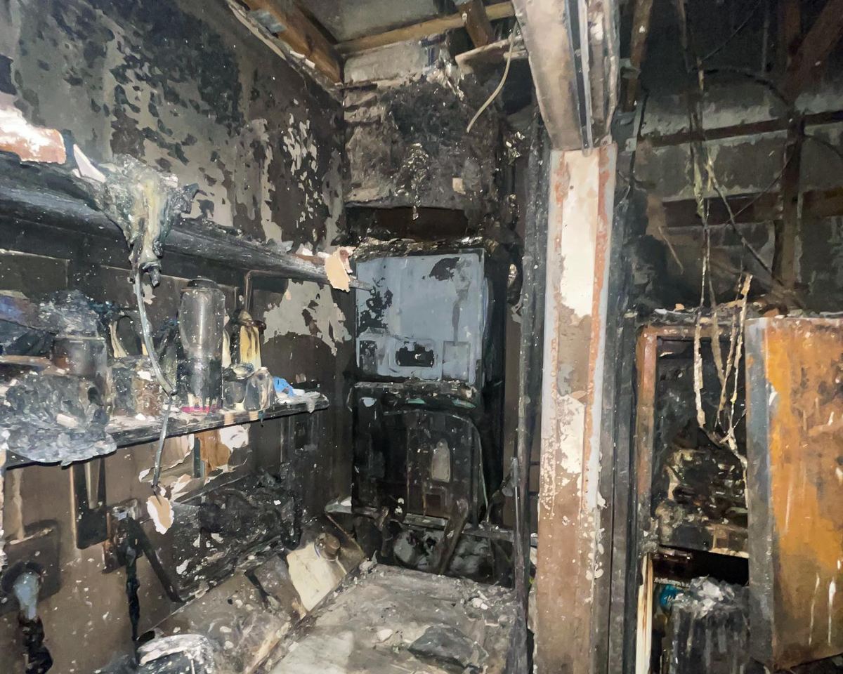 Completely burned interior room, debris and soot covering everything