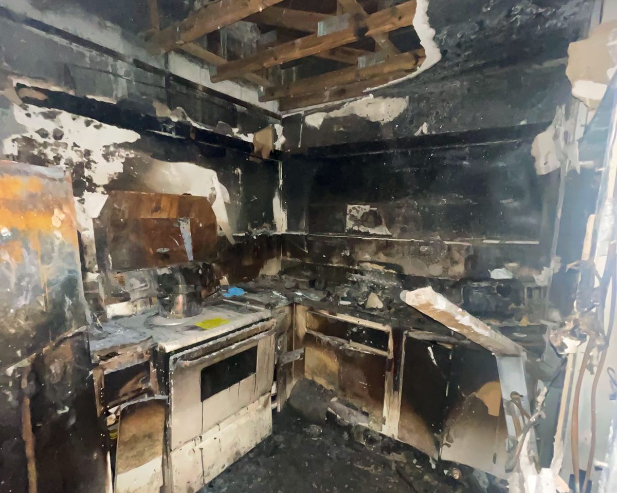 Fire-damaged kitchen, complete destruction from residential fire