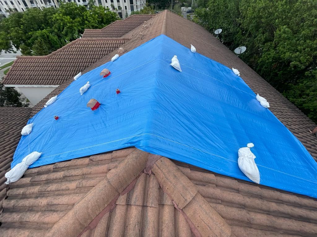 Blue roof tarp installed on South Florida home after storm damage